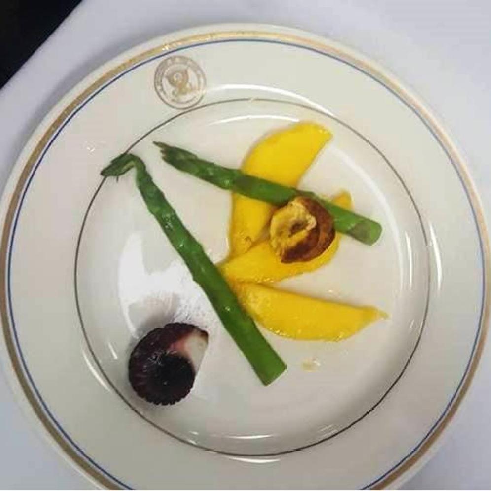 I think a more successful attempt would have been to fan out the mango in the same direction, shave the asparagus with a peeler pinched into a small mound on neatly arranged, thinly sliced rounds of octopus with bias cut plantain chips leaning against the salad.